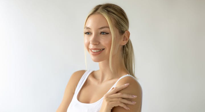 Woman in white tank top smiling