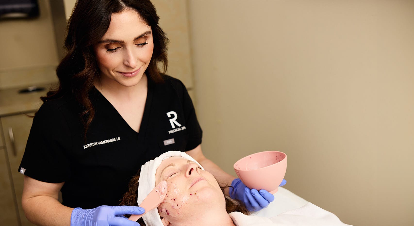 Nurse administering facial treatment