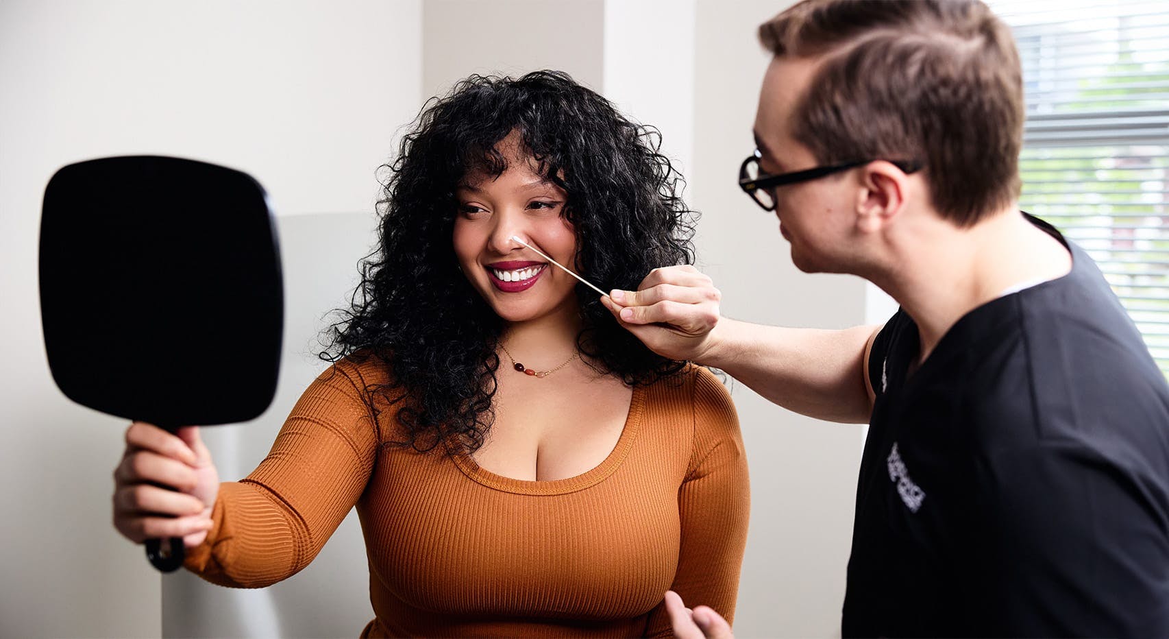 Woman receiving rhinoplasty consultation