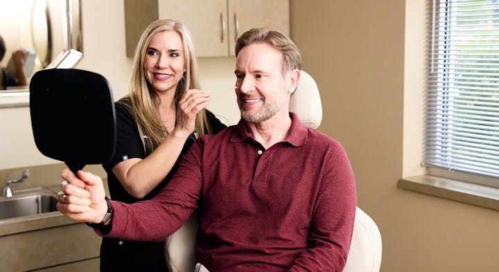 Male patient looking in mirror