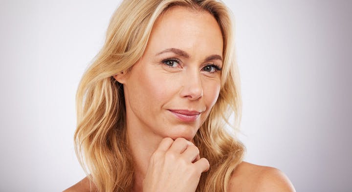 Woman smiling while holding chin