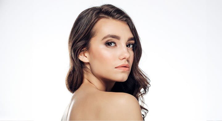 Woman smiling over shoulder