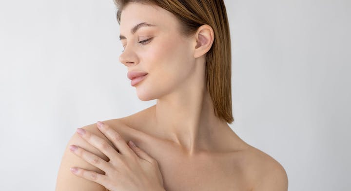 Woman running hand over shoulder