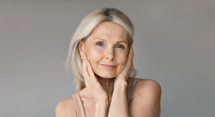 Woman holding cheeks