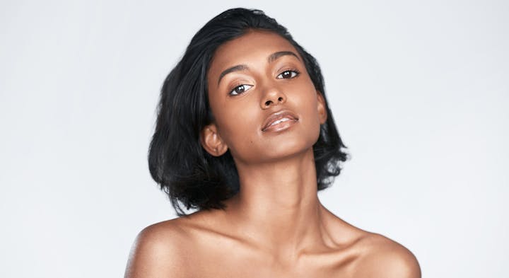 Woman smiling over shoulder