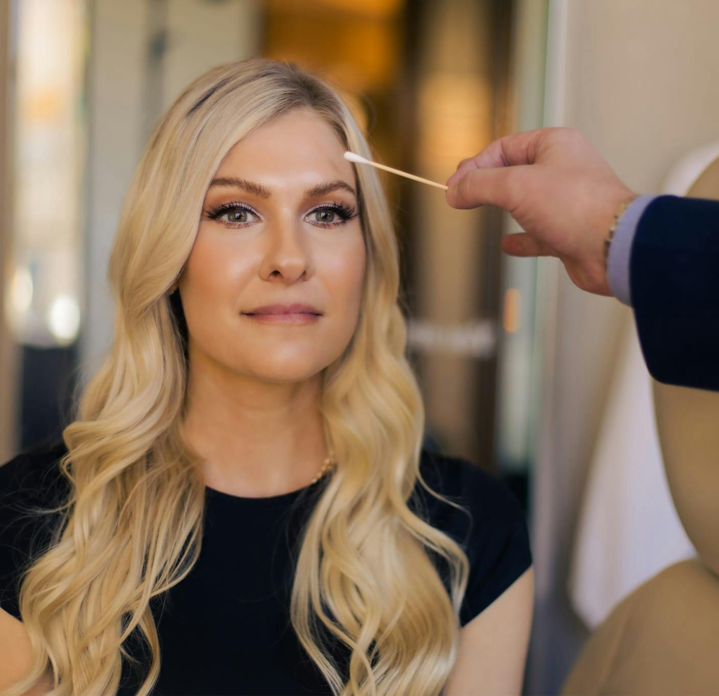 woman getting her forehead checked by doctor