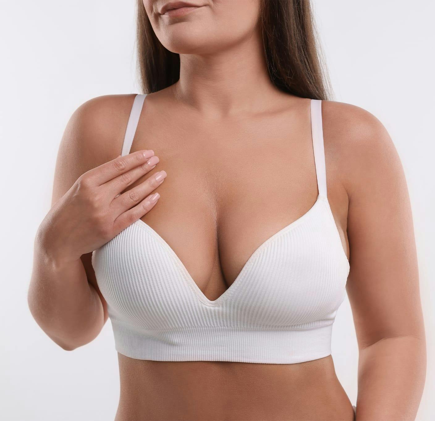 woman holding her bra strap