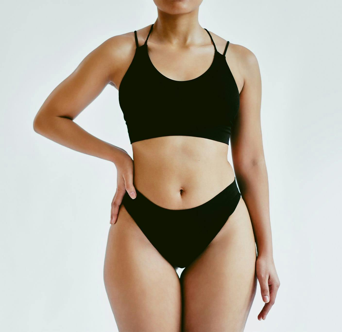 Woman in a bodysuit smiling