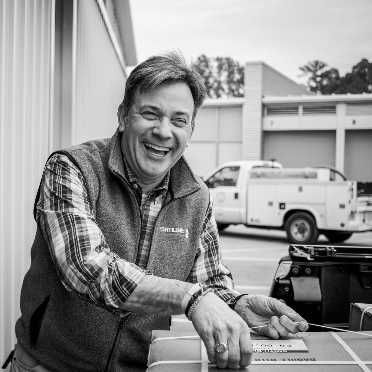 Smiling Fortiline employee packing boxes
