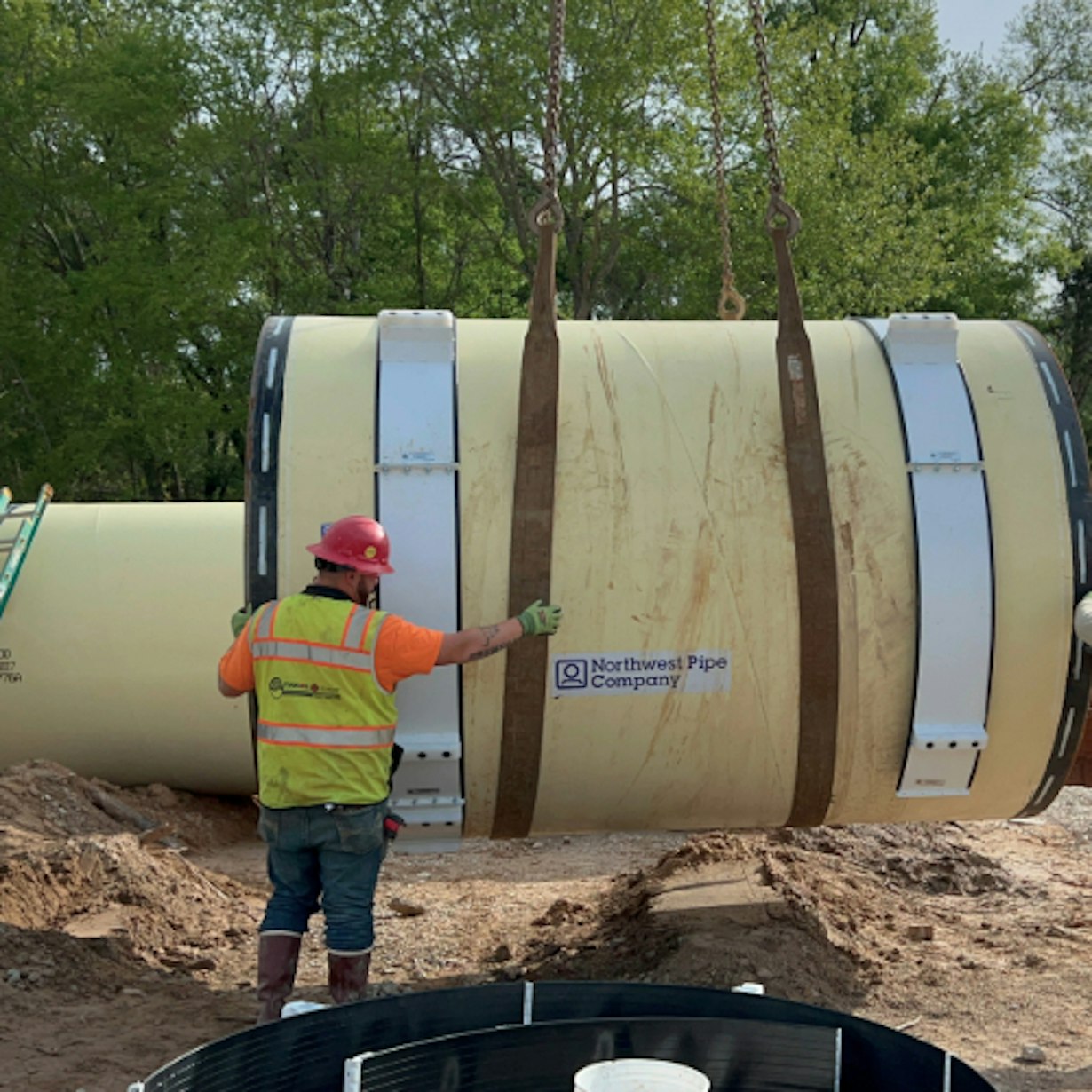 Contractor installing big pipe