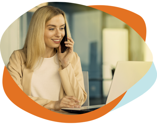 A lady is on the phone while looking at her laptop. She is an underwriter using Decision Platforms automated claims software for underwriters.