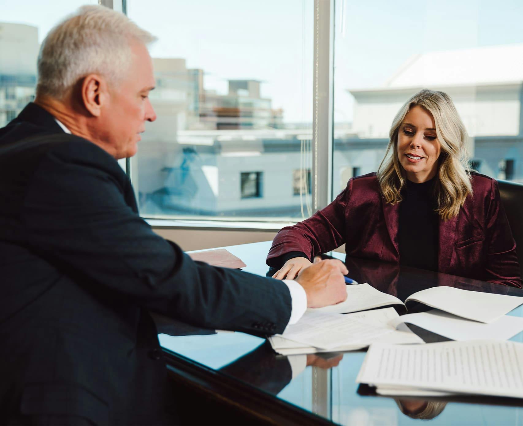attorney and client looking at documents