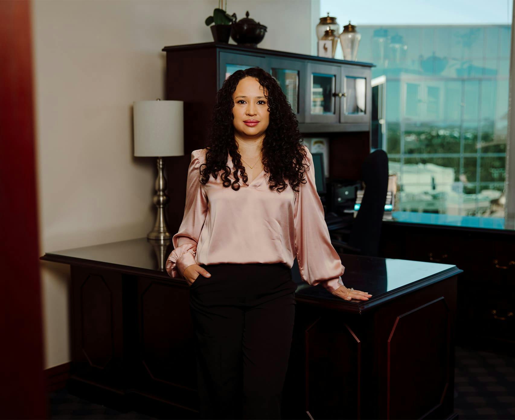 female attorney standing in front of desk