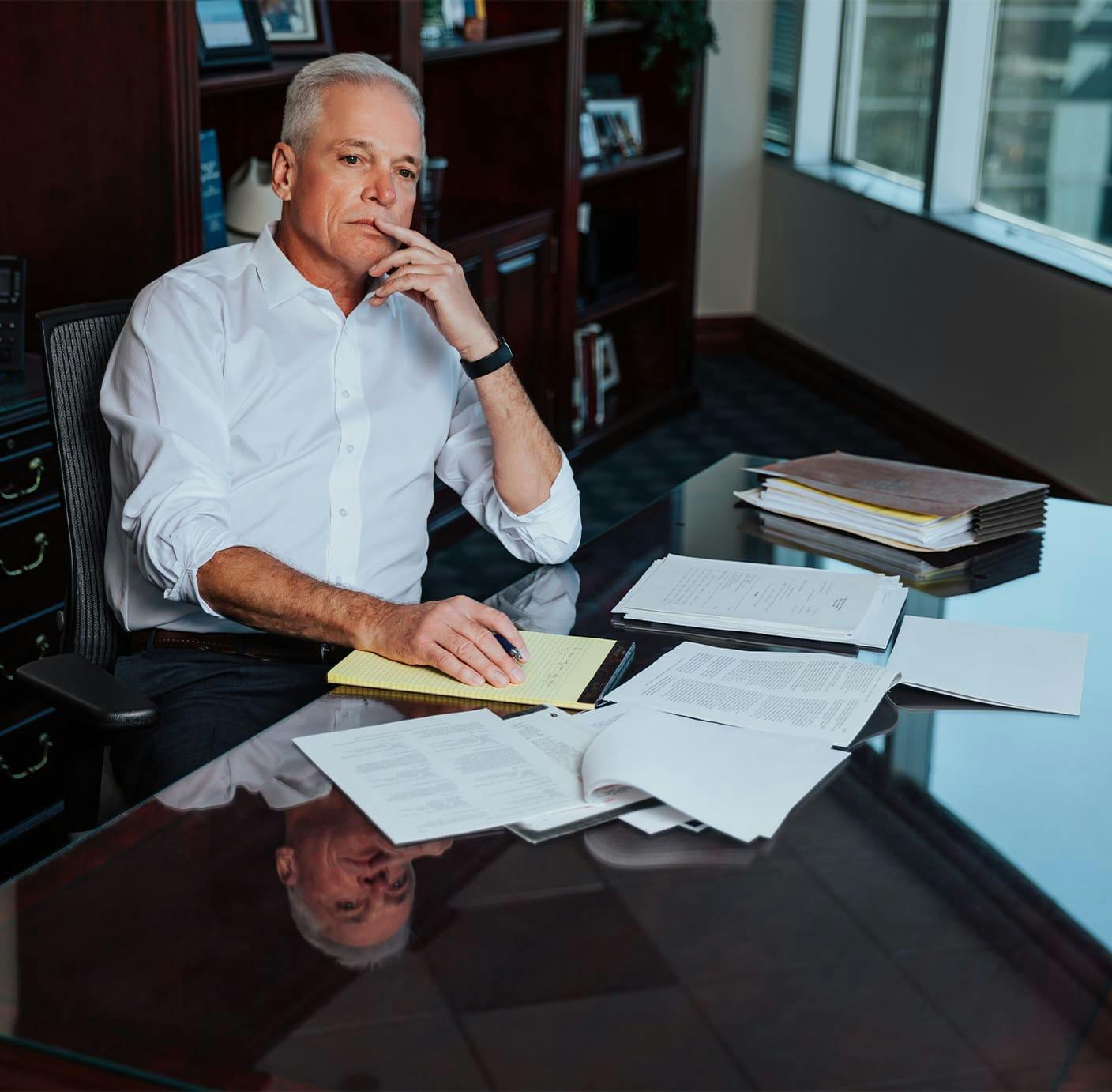 attorney at table thinking