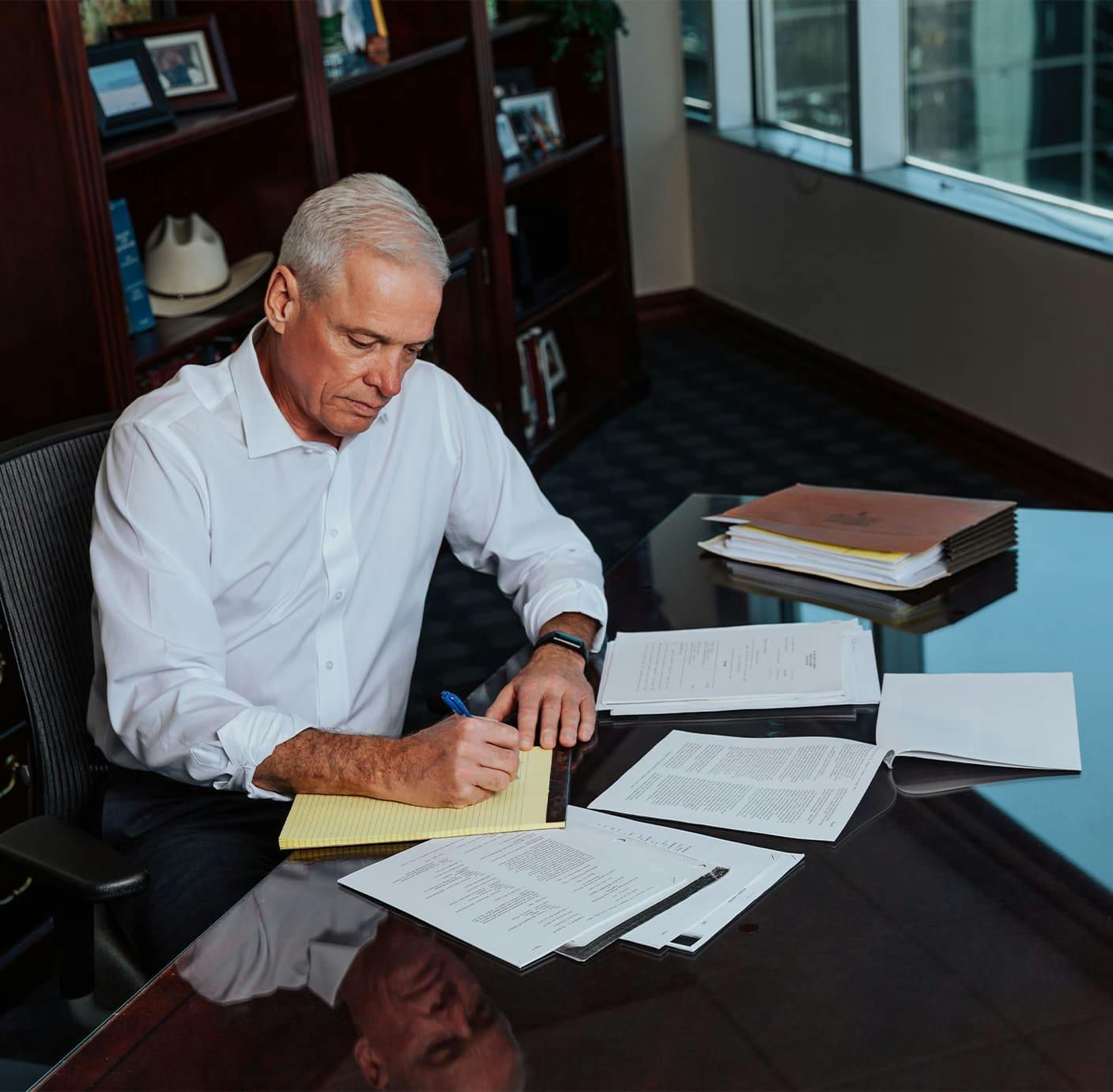 attorney sitting at table writing