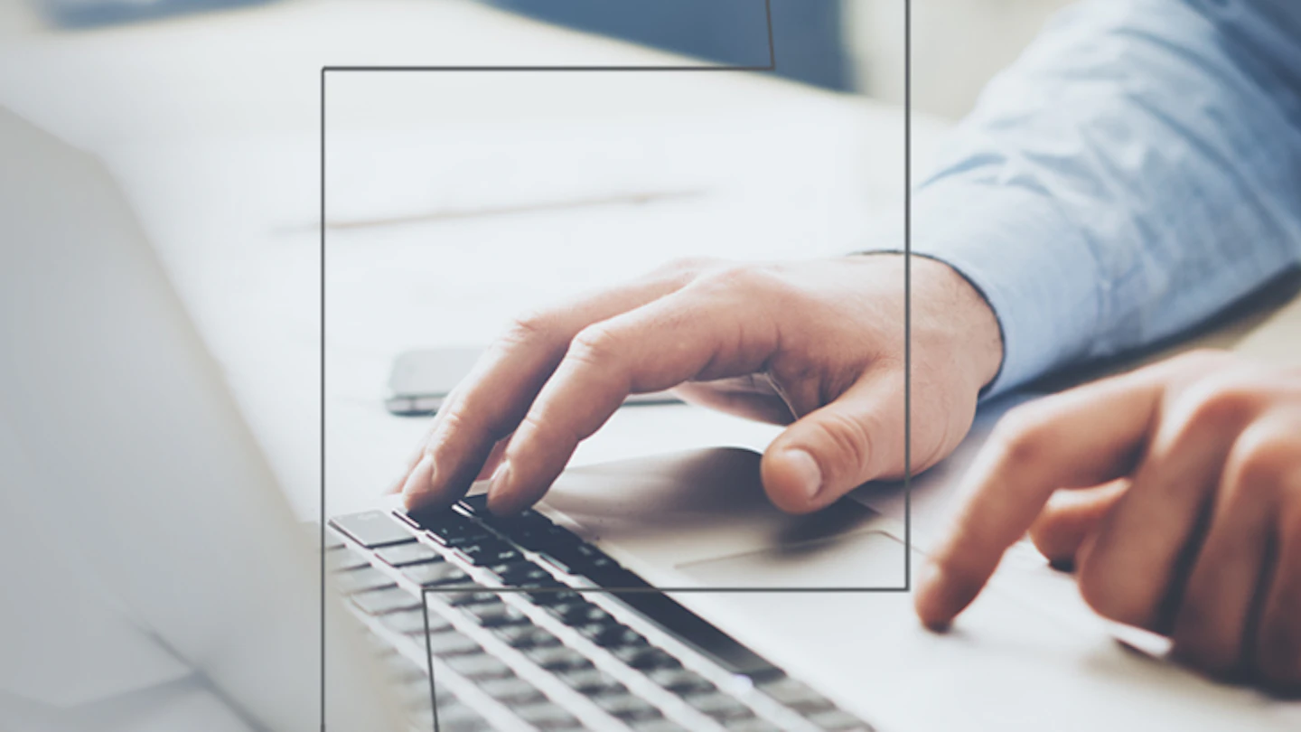 Pair of hands using laptop