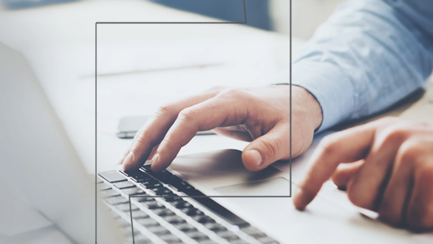 Pair of hands using laptop