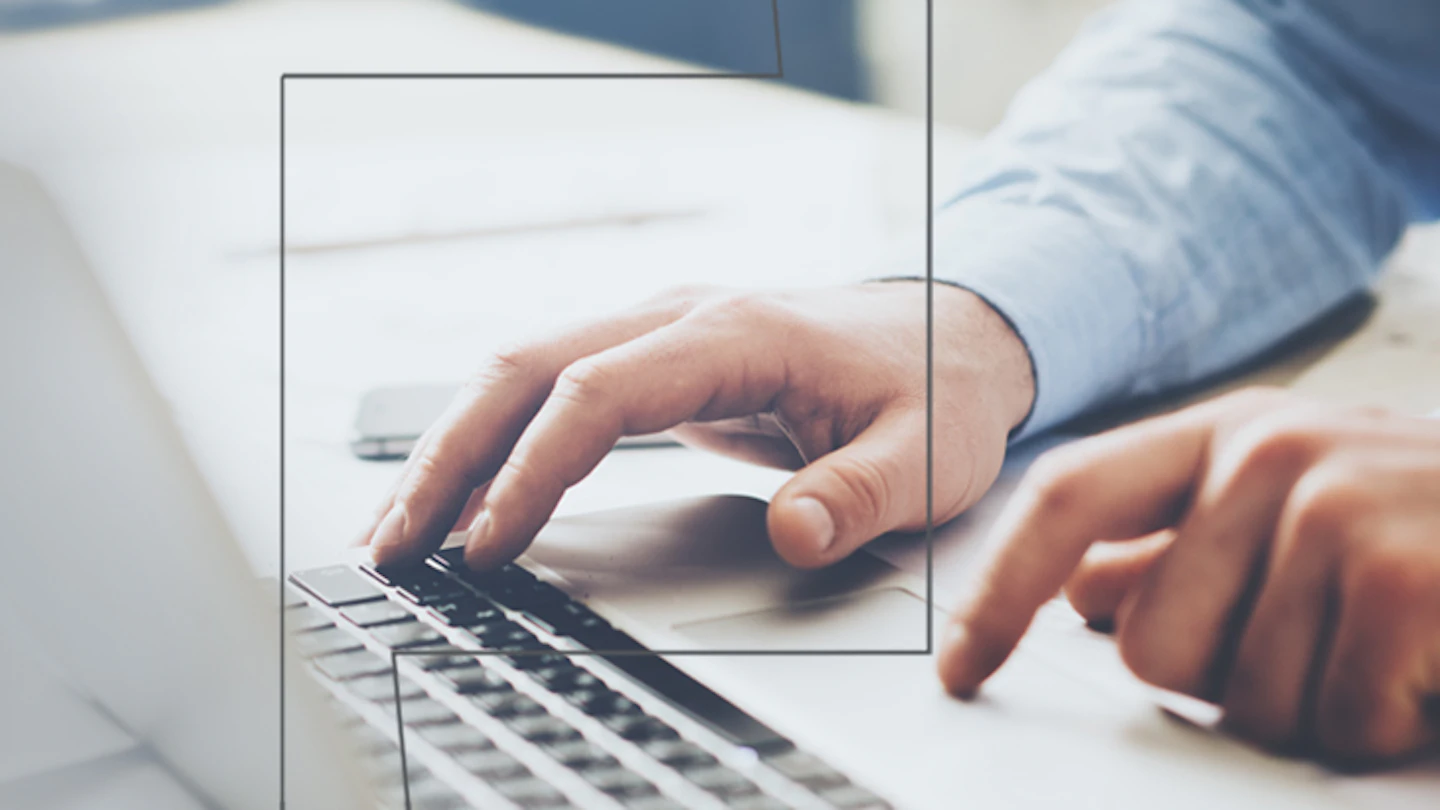 Professional hands on a laptop keyboard