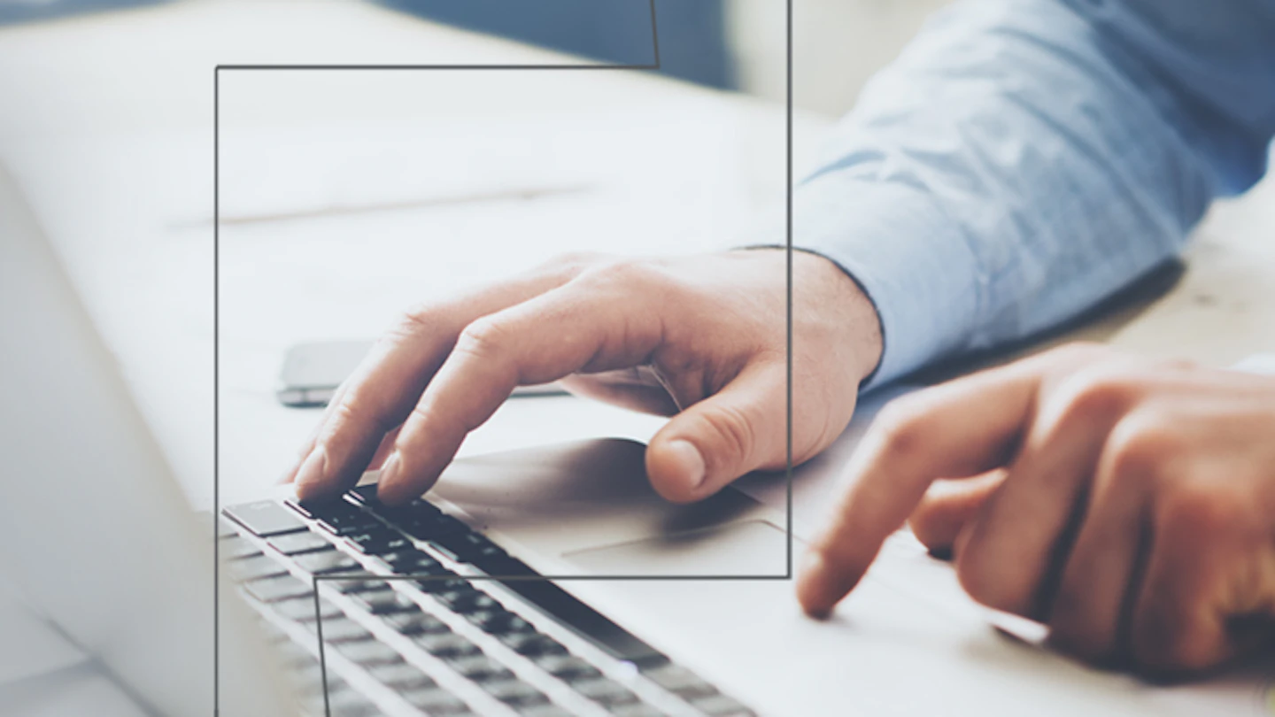 Pair of hands using laptop