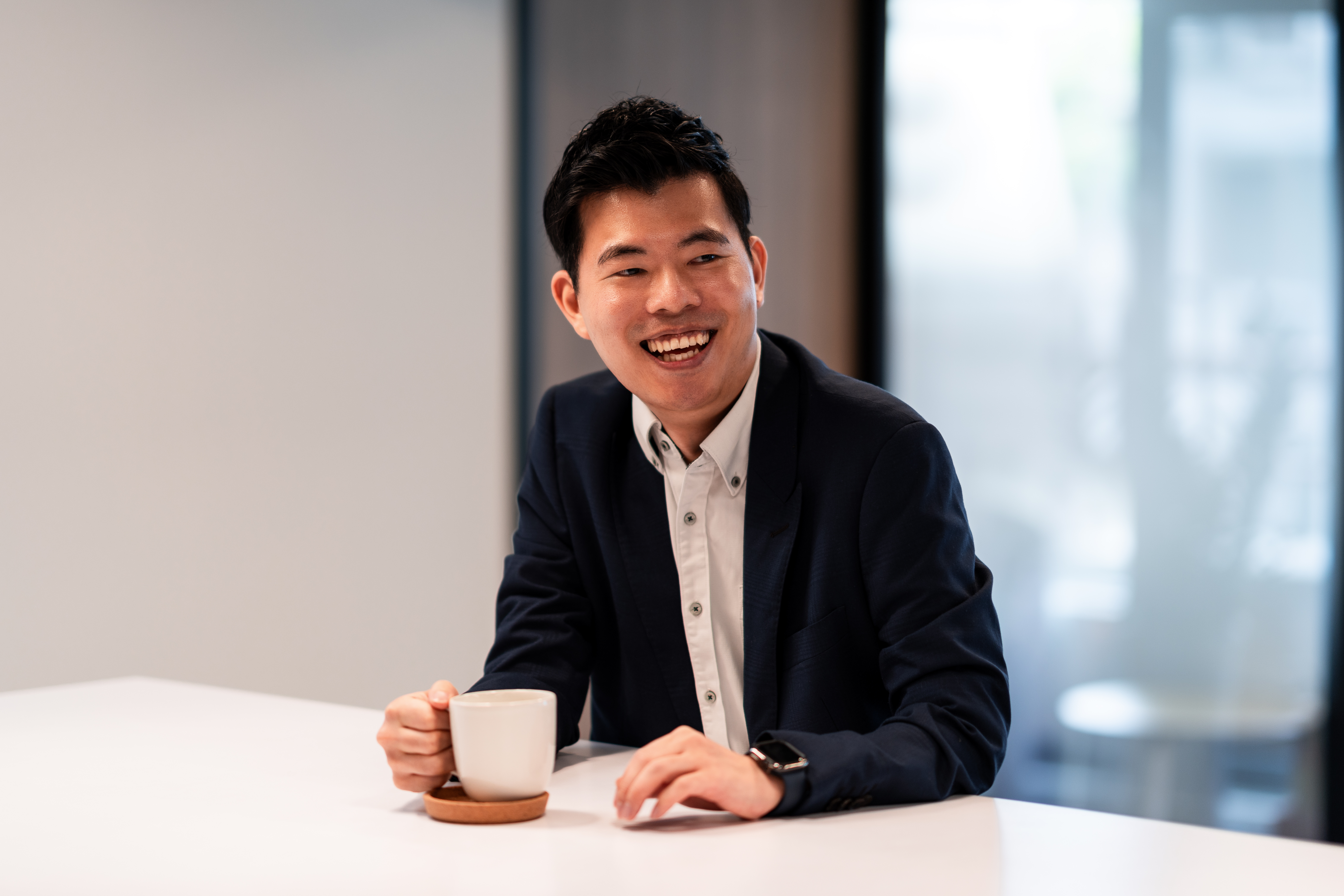 TW - Man with coffee cup sitting at table