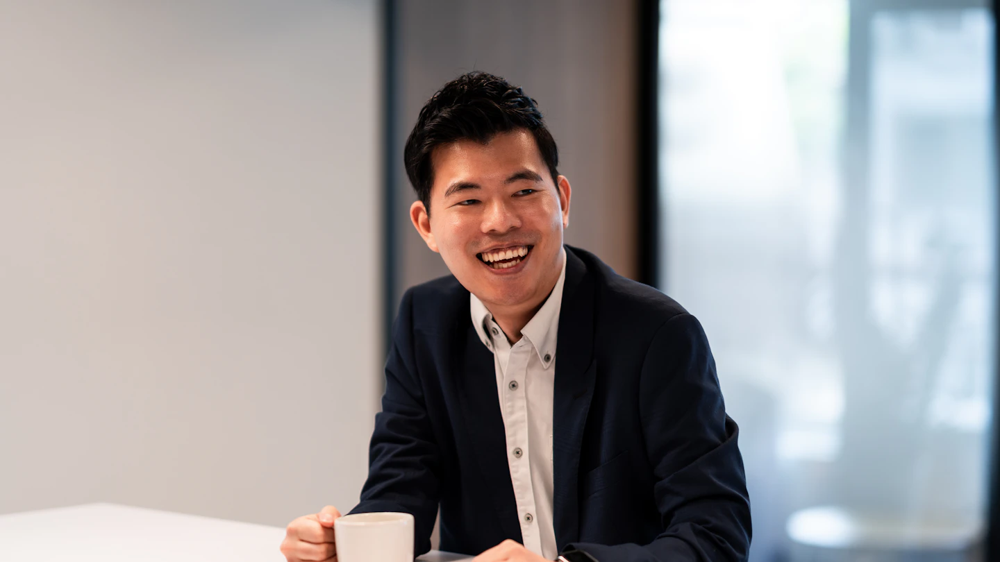 TW - Man with coffee cup sitting at table