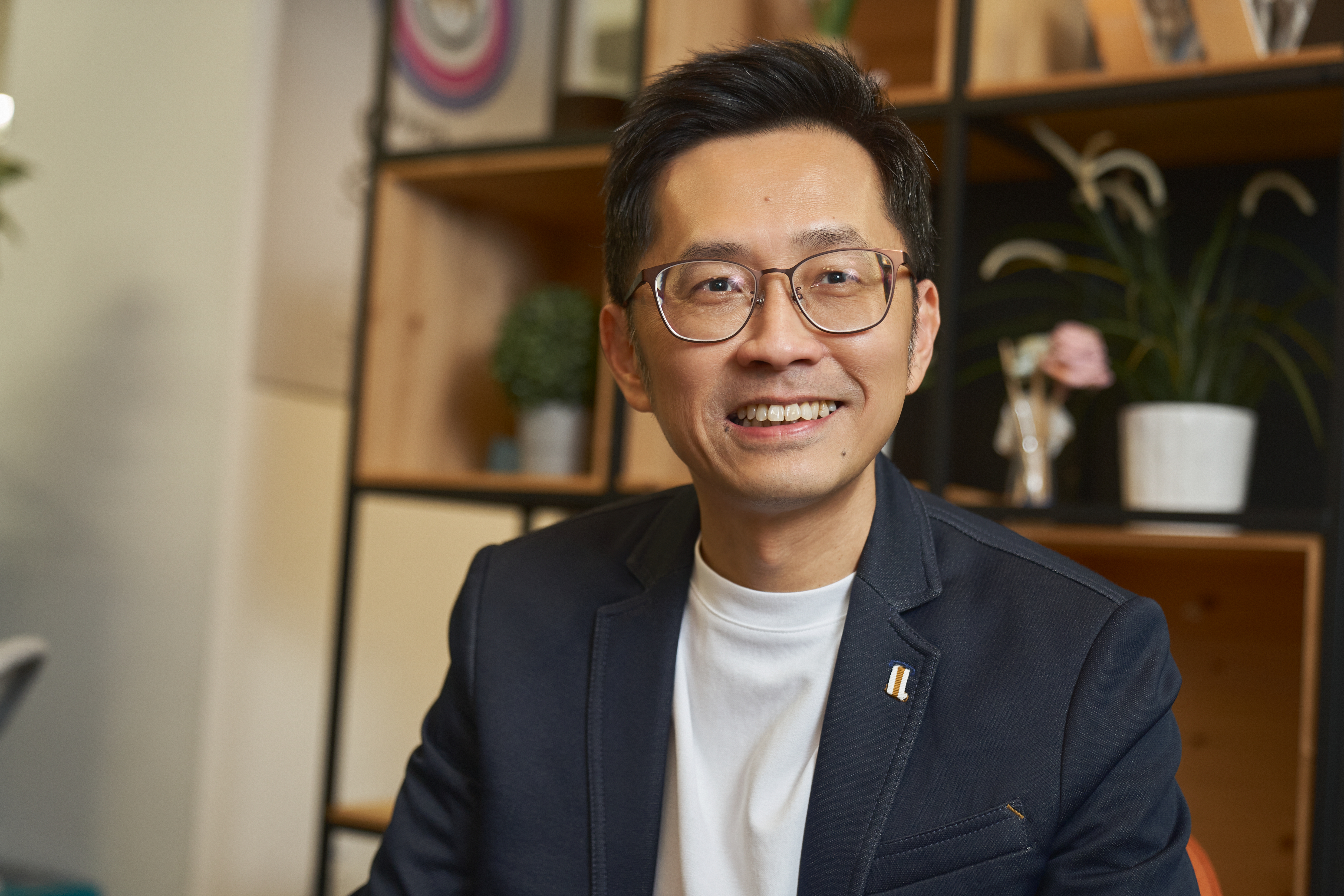 SG - man smiling at camera in an office