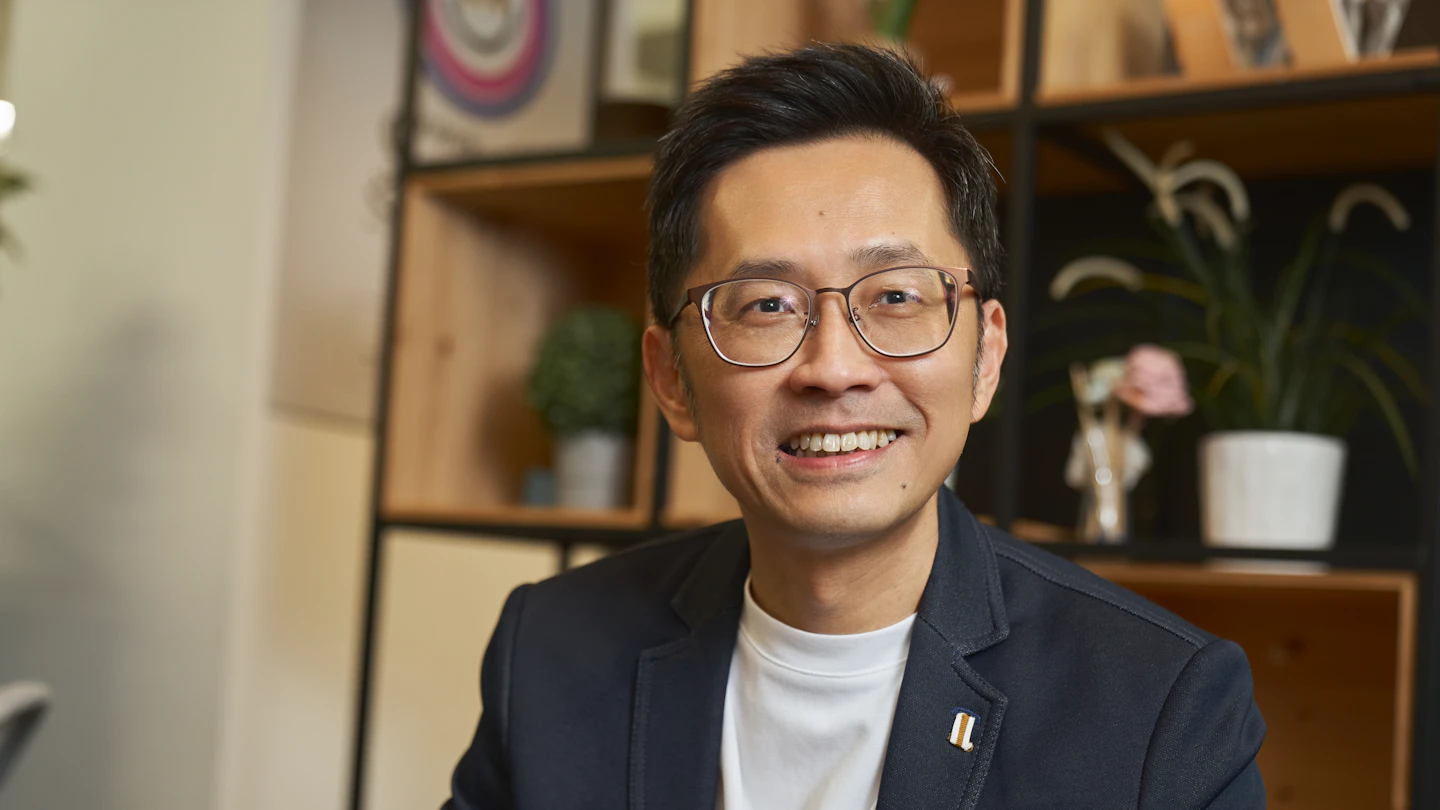 SG - man smiling at camera in an office