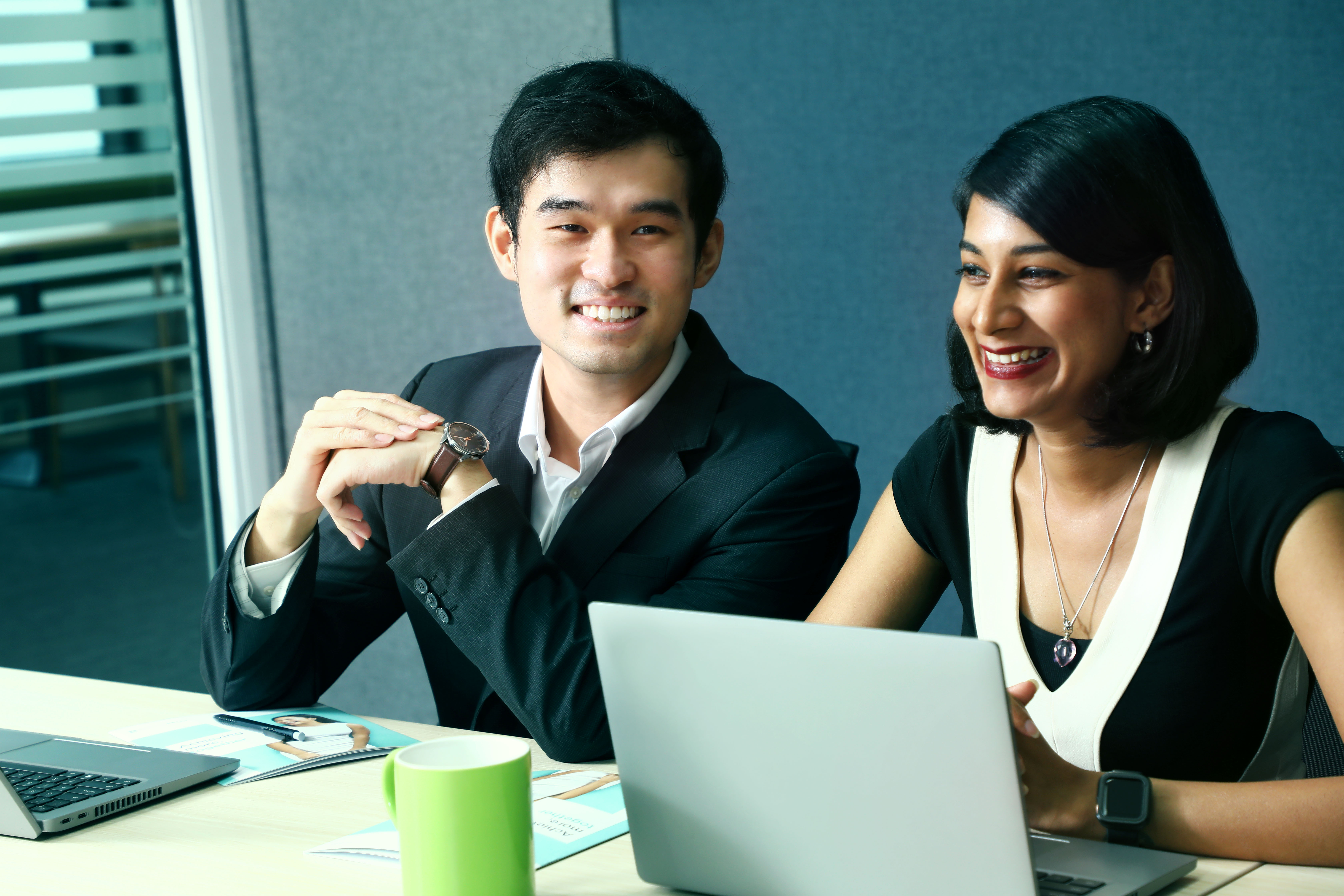 MY - Man and woman sitting at a work desk