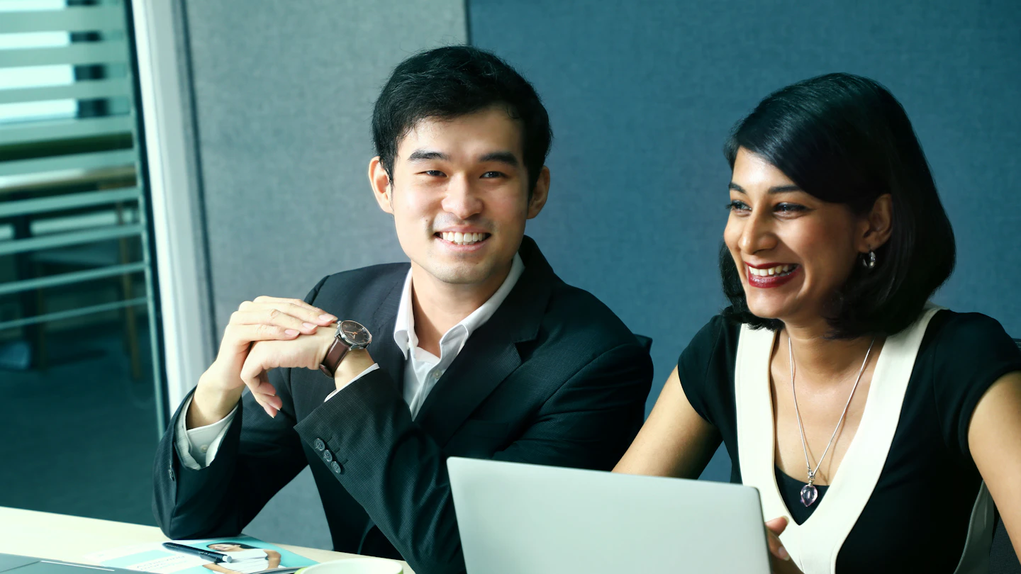 MY - Man and woman sitting at a work desk