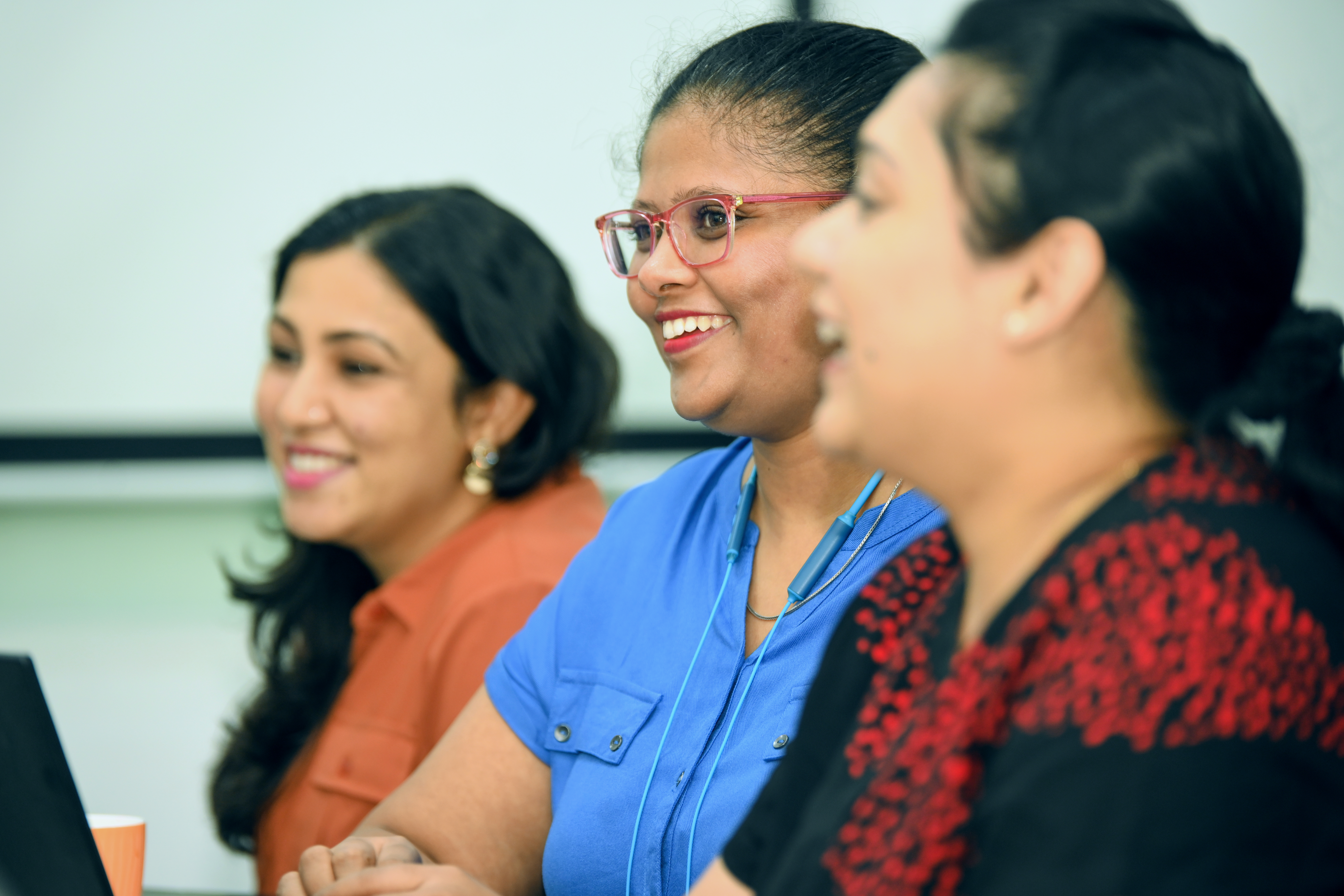IN - women smiling at an office