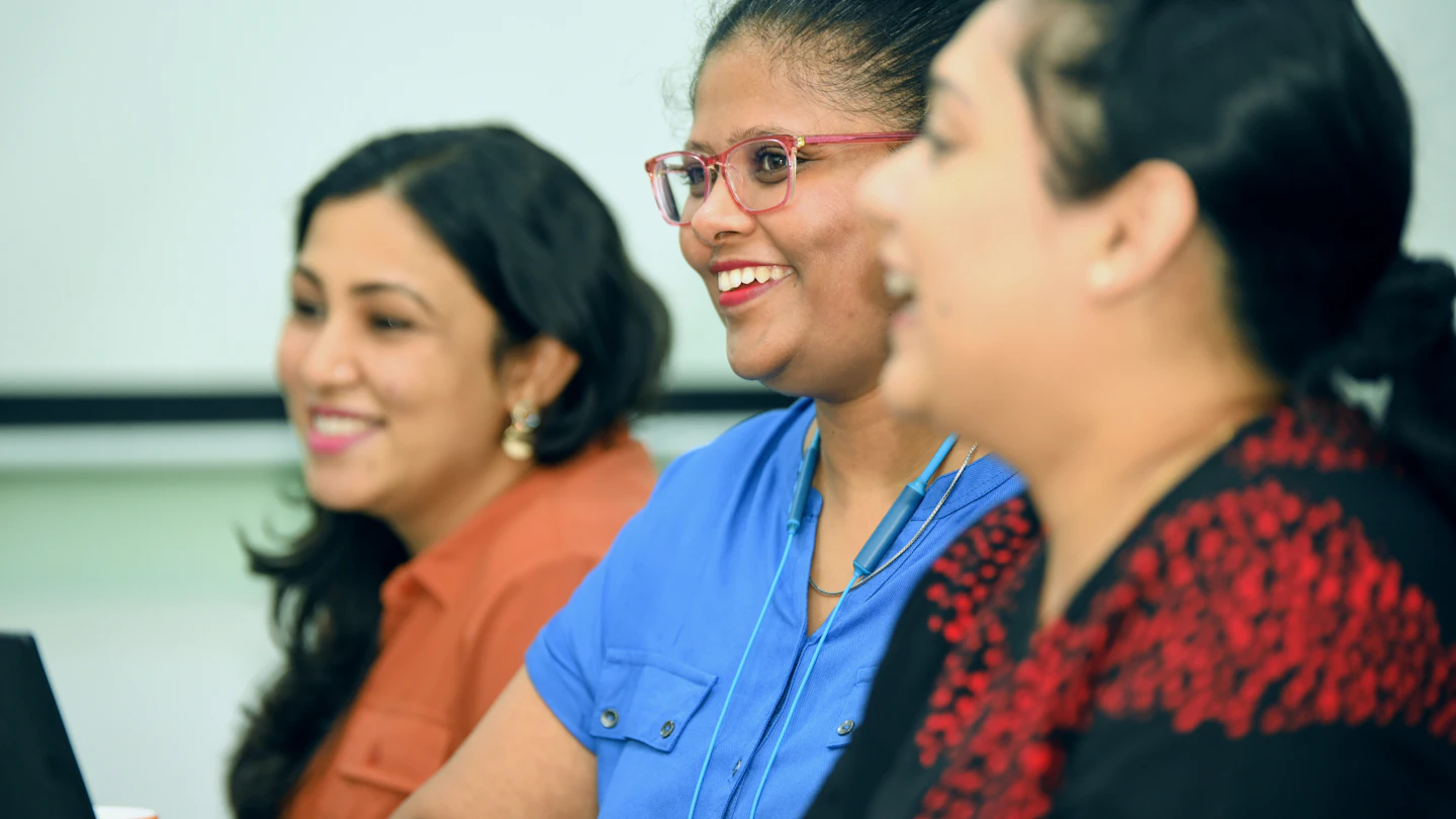 IN - women smiling at an office