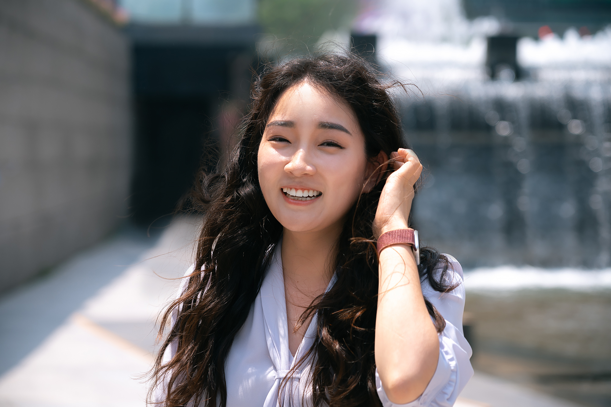 KR - woman smiling while outdoors