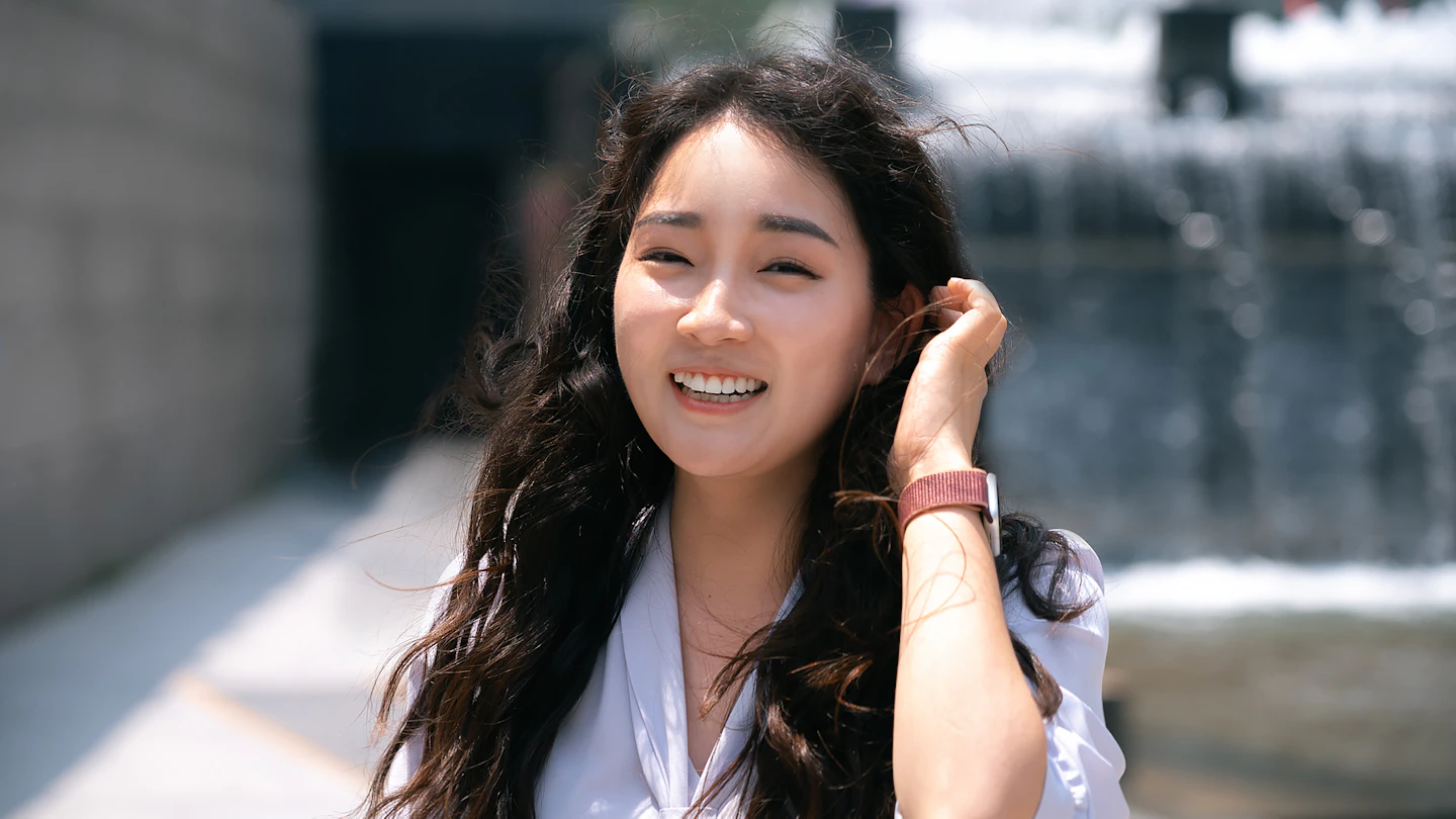 KR - woman smiling while outdoors