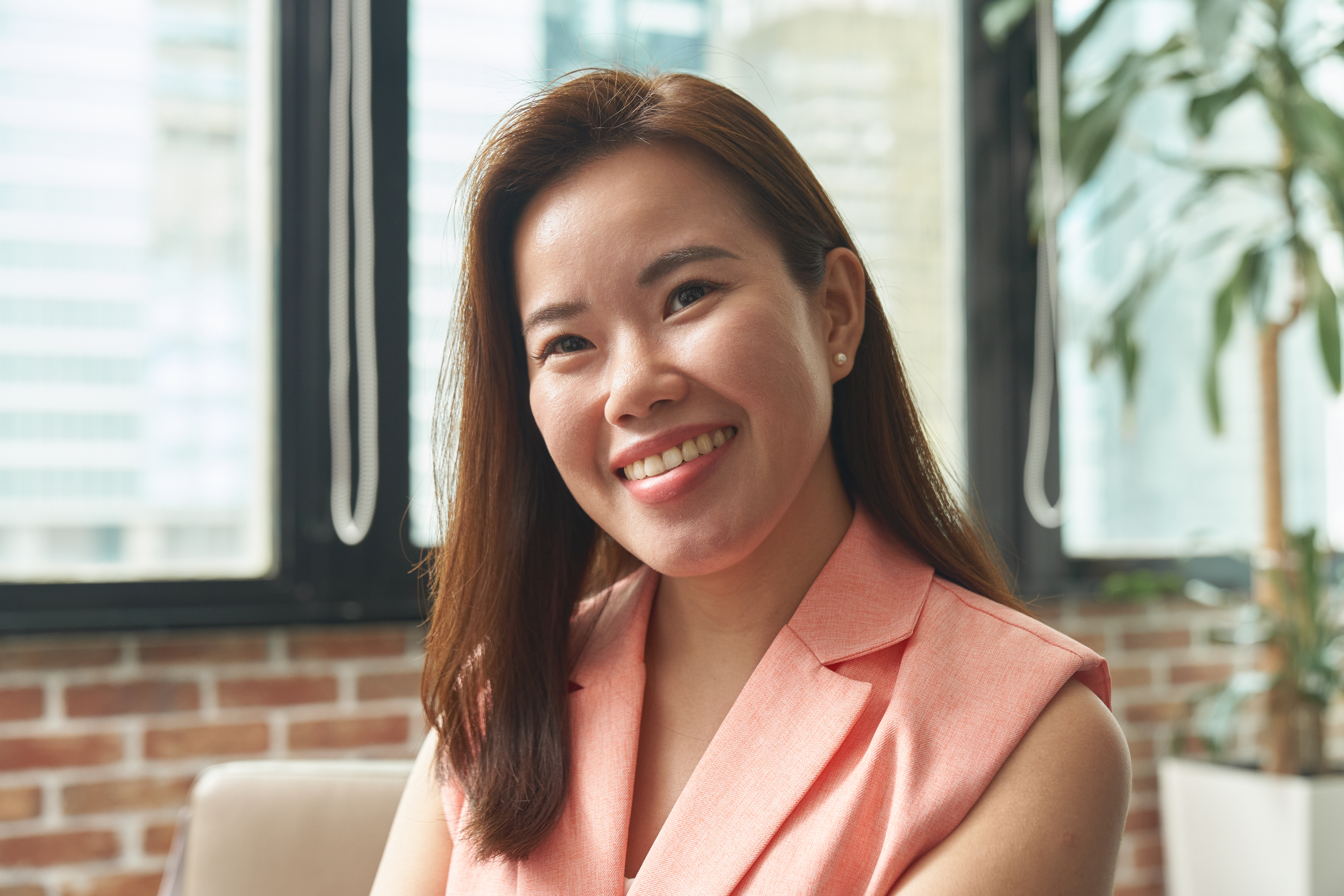 SG - woman in an office smiling at the camera