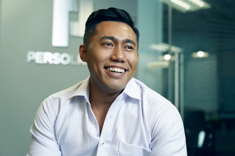 SG - smiling man wearing a white shirt