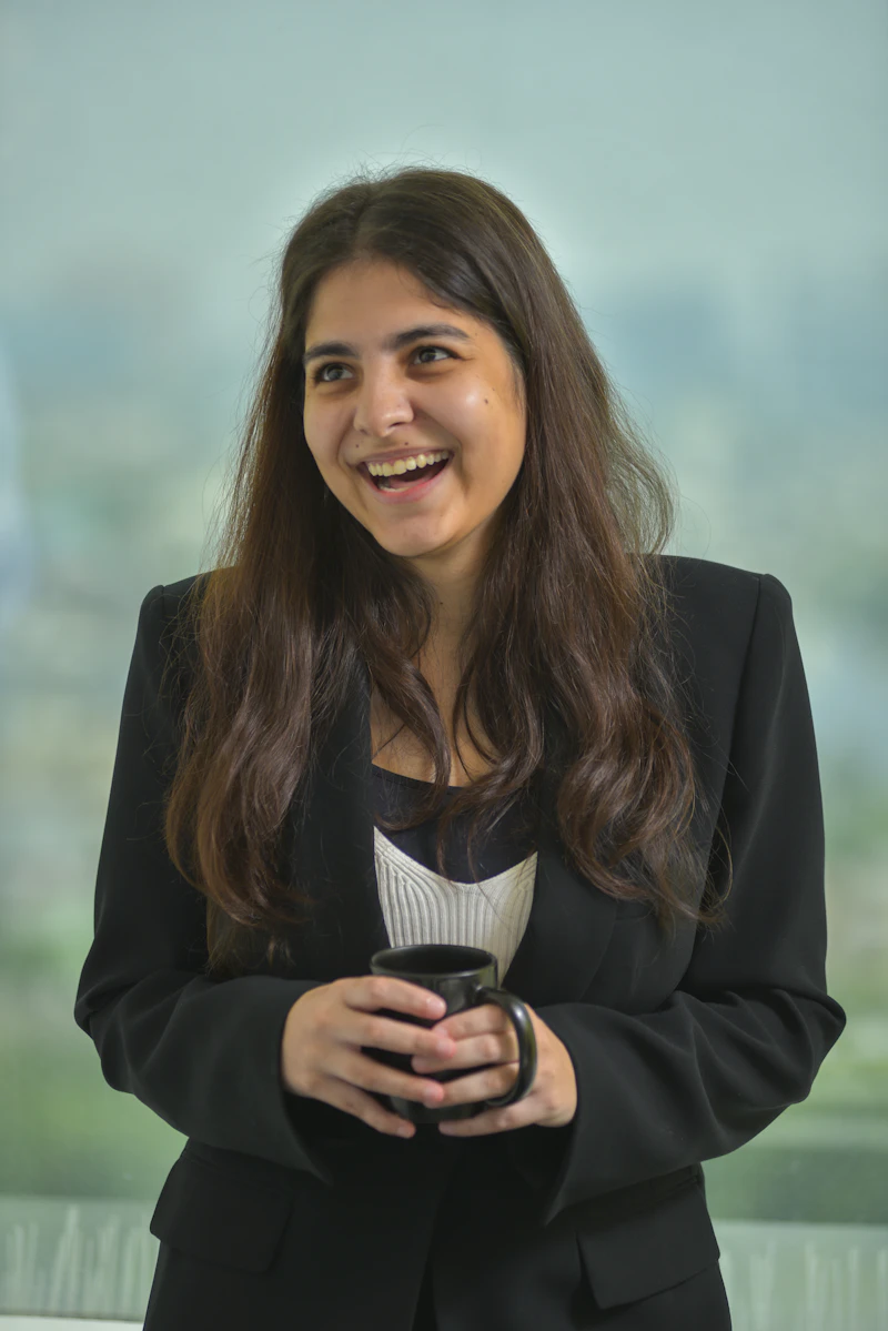 IN - smiling woman holding a coffee cup