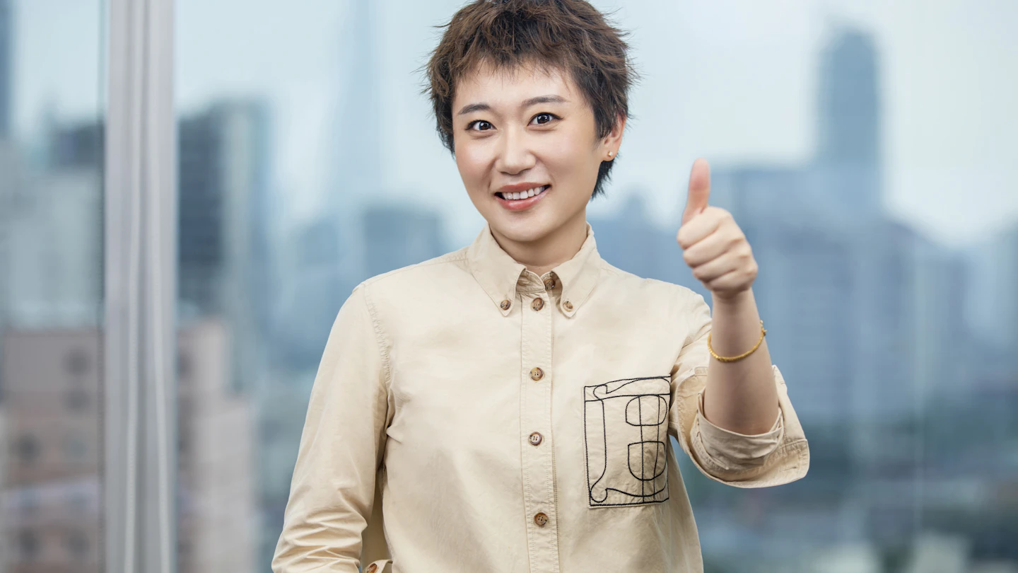 HK -  smiling woman giving thumbs up
