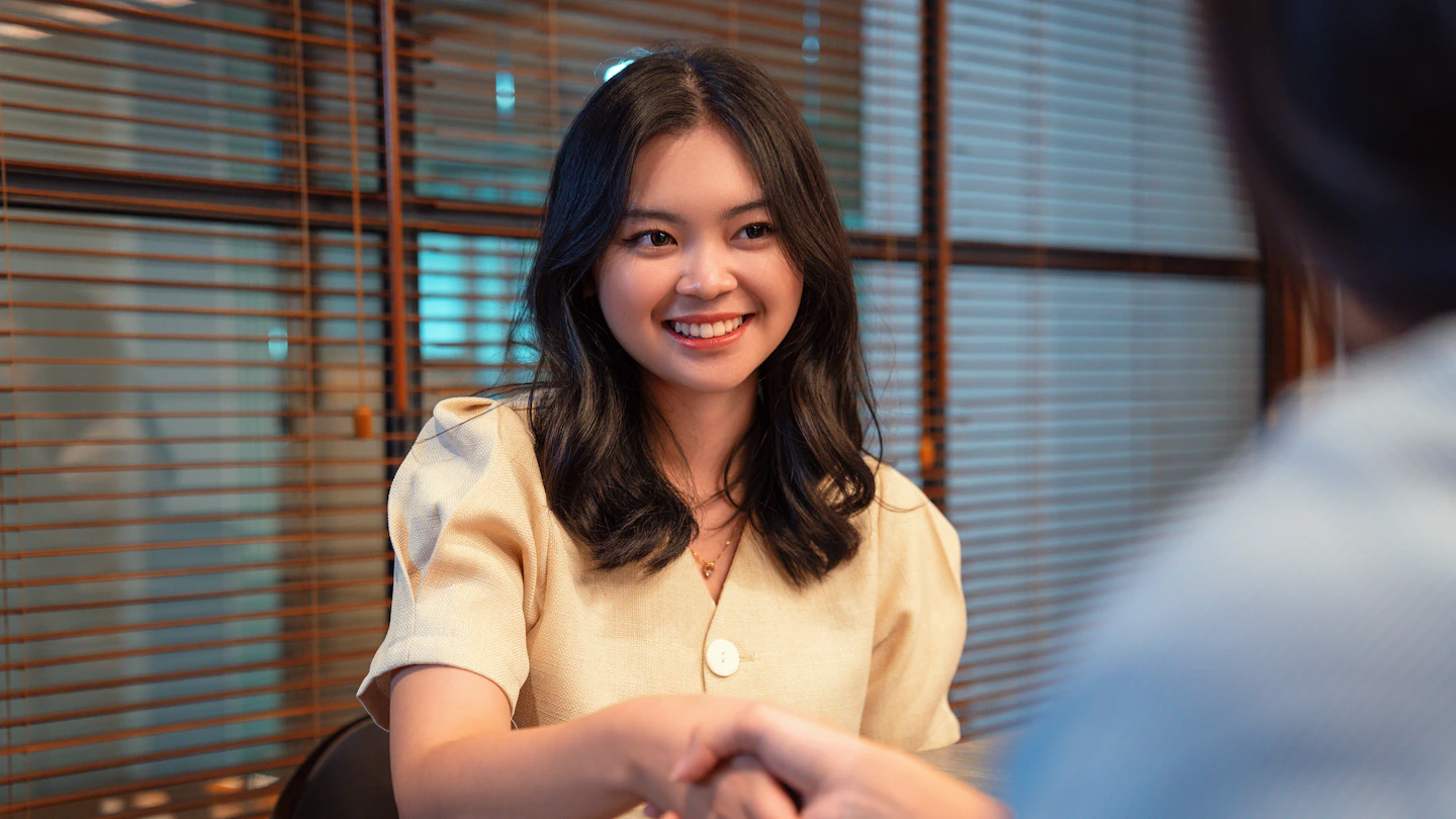 ID - smiling woman shaking hands