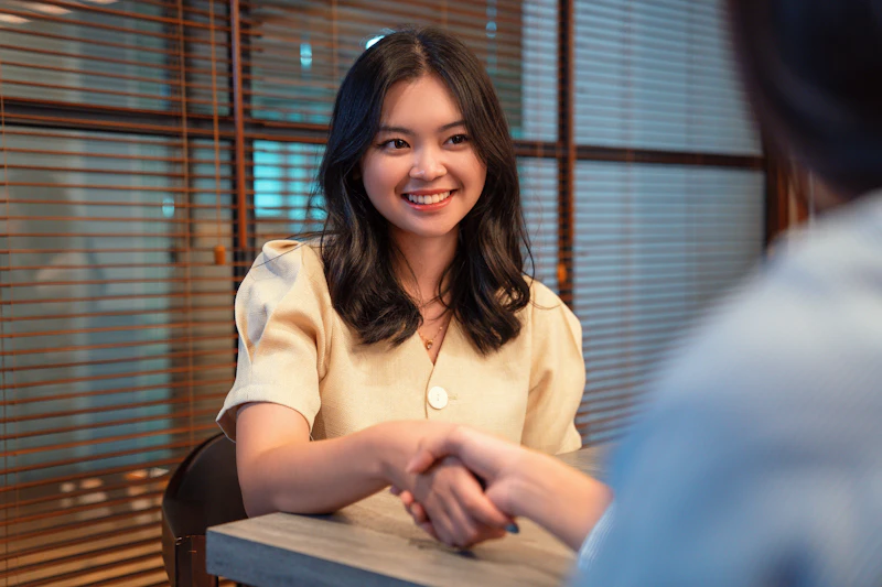 ID - smiling woman shaking hands