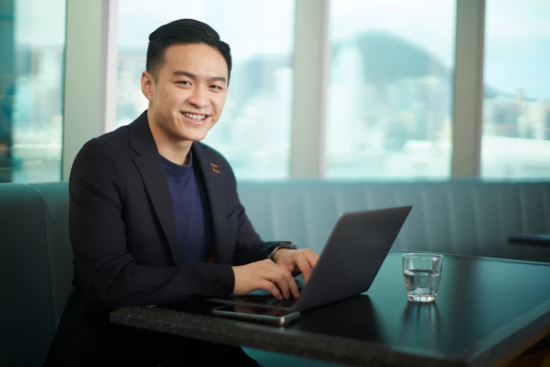 Smiling man sitting at a laptop