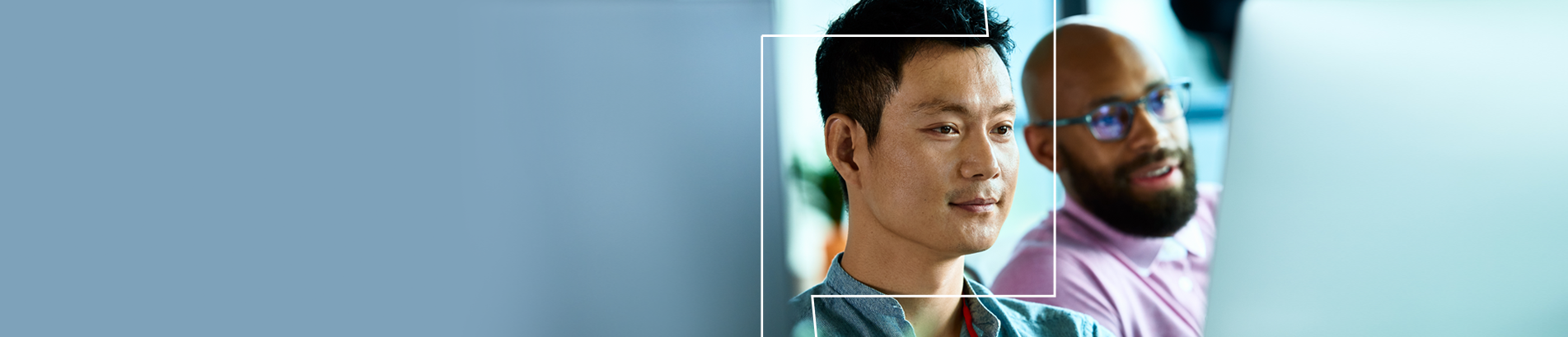 Close up picture of two men looking off camera