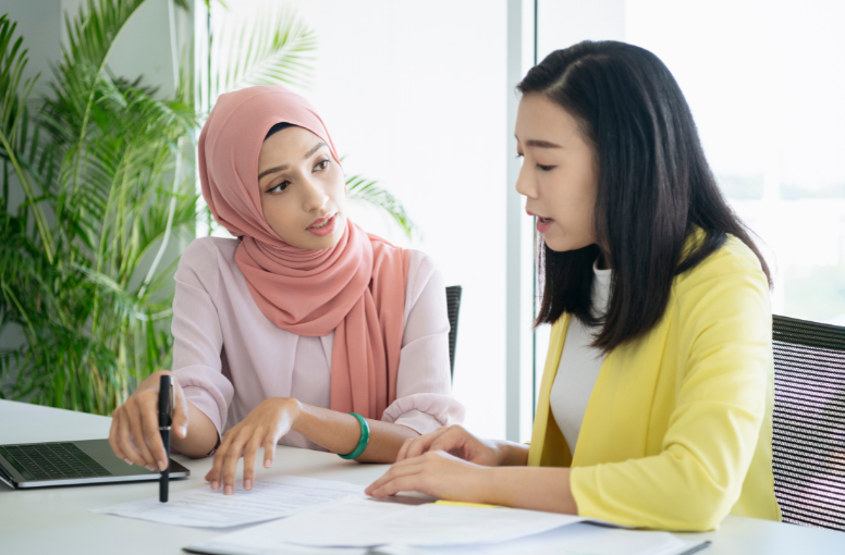 woman wearing hijab with chinese lady
