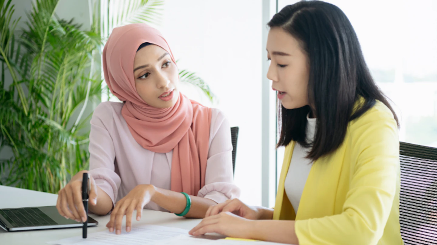 woman wearing hijab with chinese lady