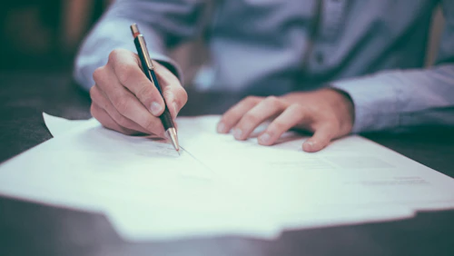 rehiring man writing on paper
