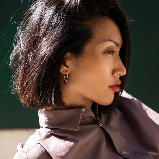 Woman with black hair looking to the side