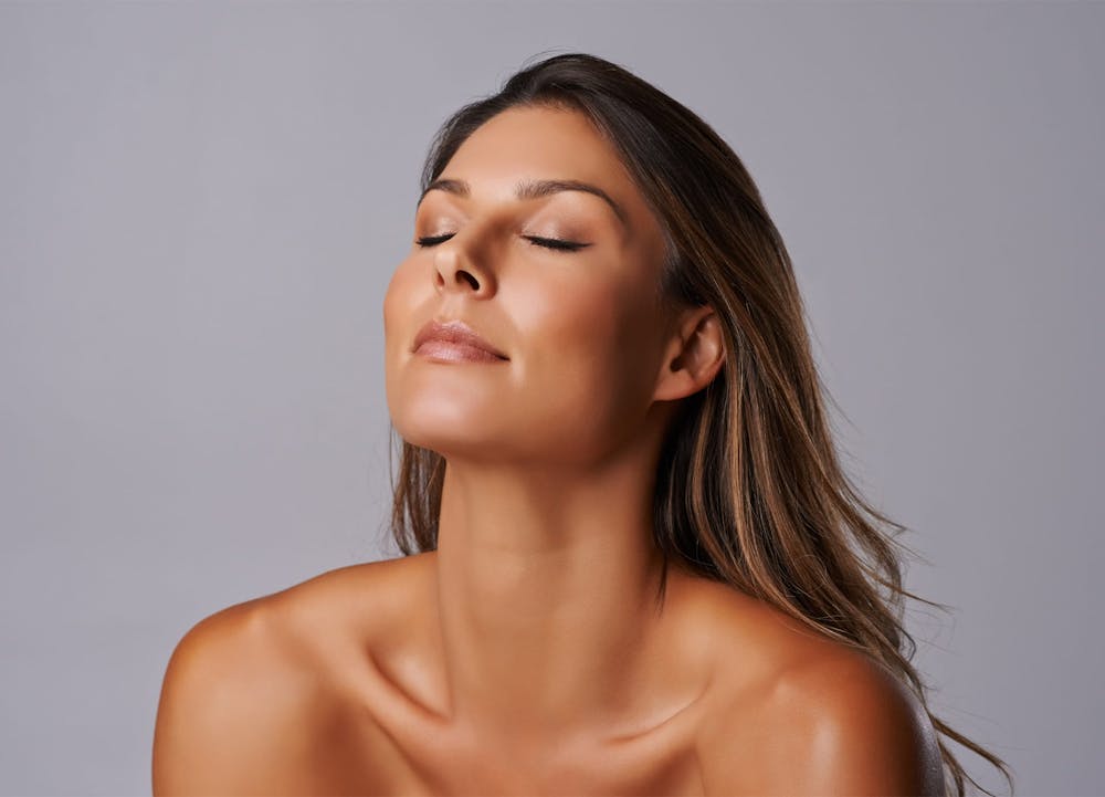woman smiling with eyes closed