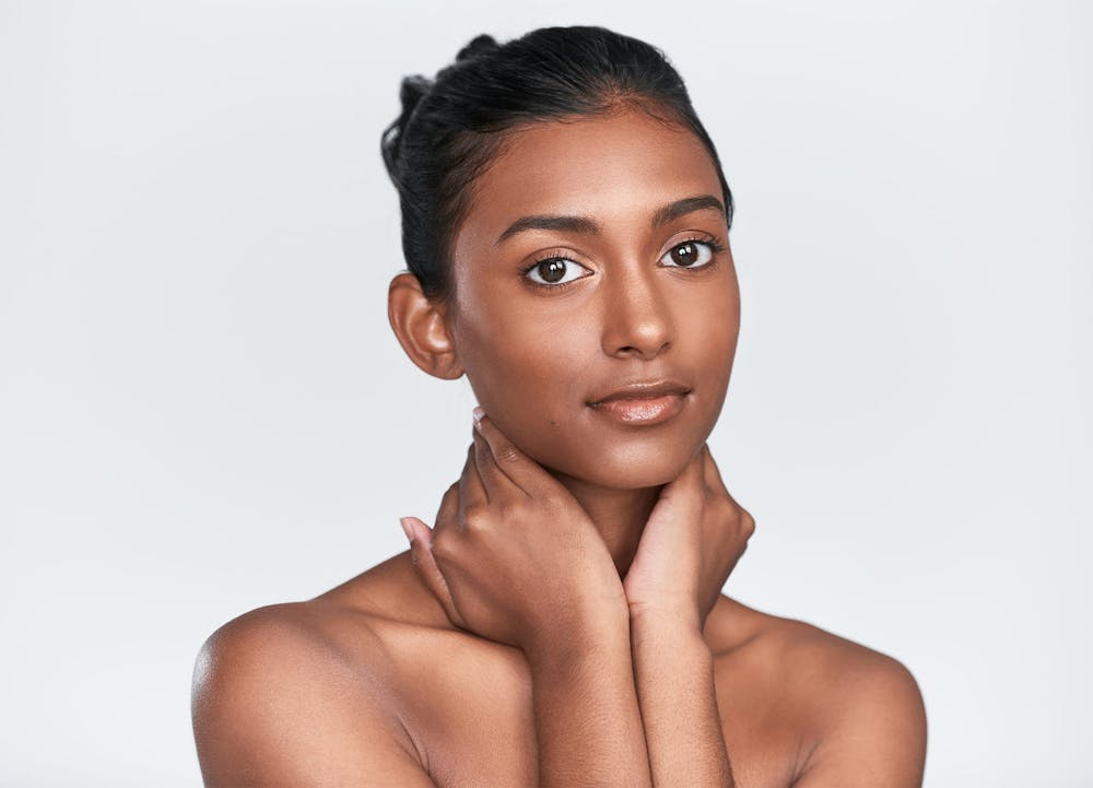 woman resting hands on neck