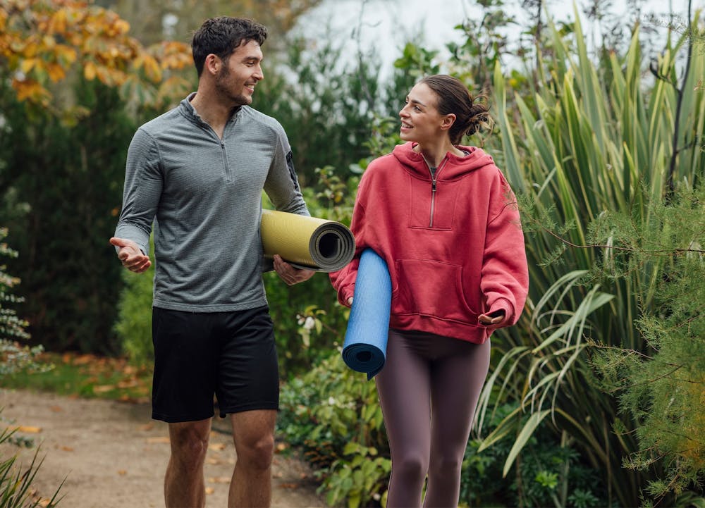 Man and woman with yoga mats