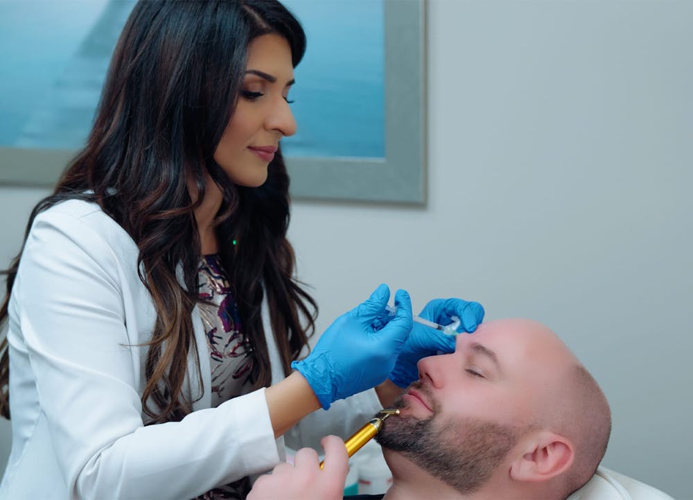 Dr. Sandhu applying facial injection