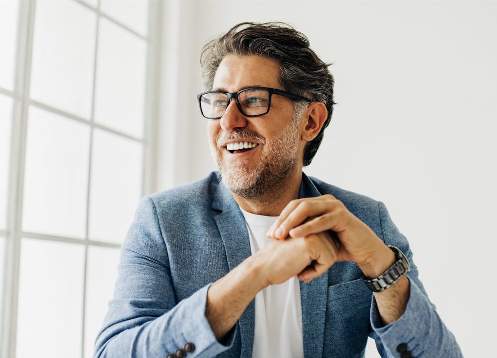 man with glasses smiling